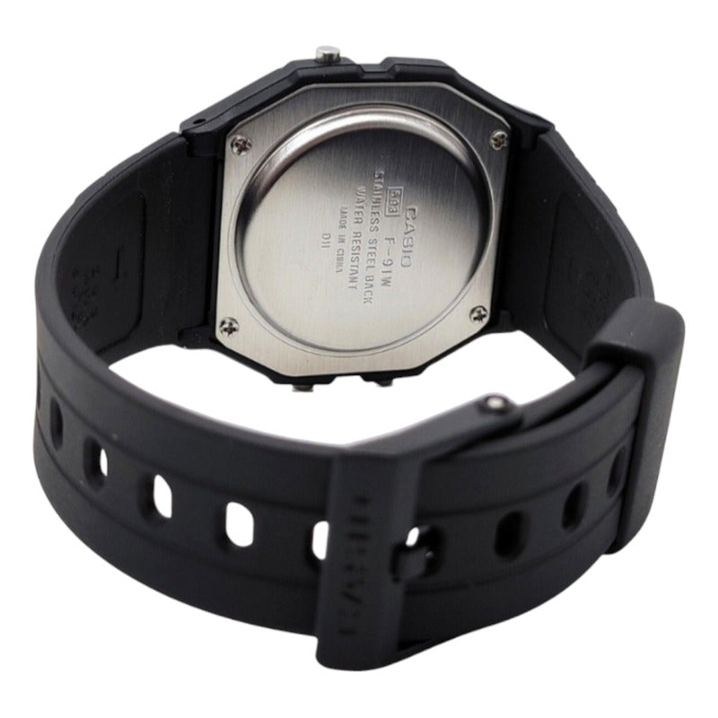 Reloj De Pulsera Casio Collection F-91w-3dg De Cuerpo Color Negro, Digital, Para Hombre, Fondo Gris, Con Correa De Resina Color Negro, Dial Negro, Bisel Color Verde Y Hebilla Sim
